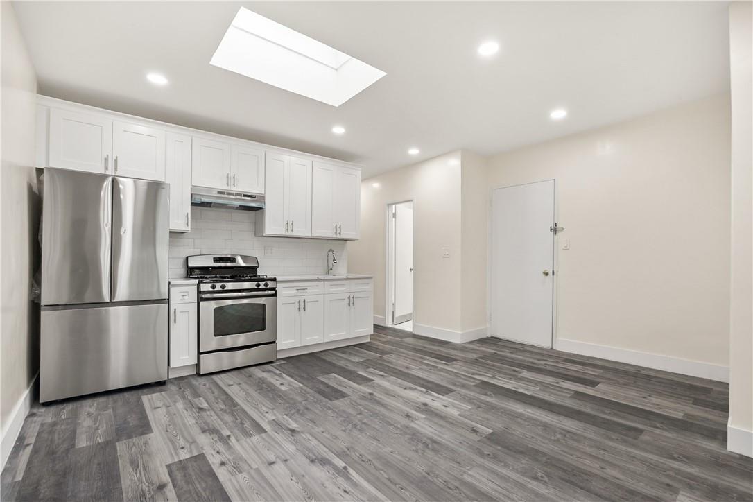 a kitchen with stainless steel appliances a refrigerator sink and microwave