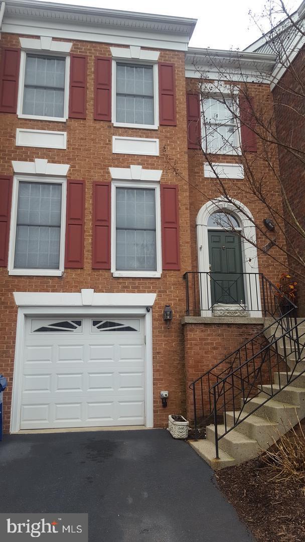 a view of a brick house with large windows