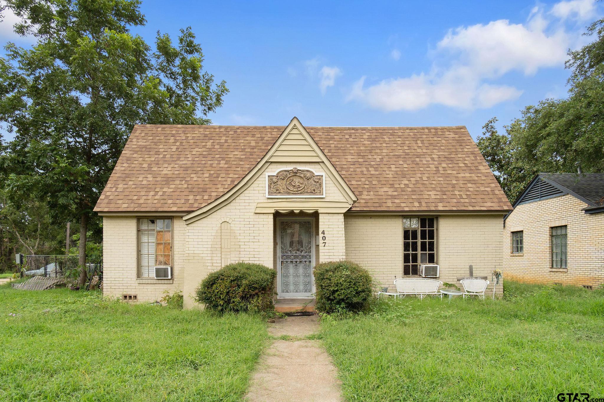 a front view of a house with a garden