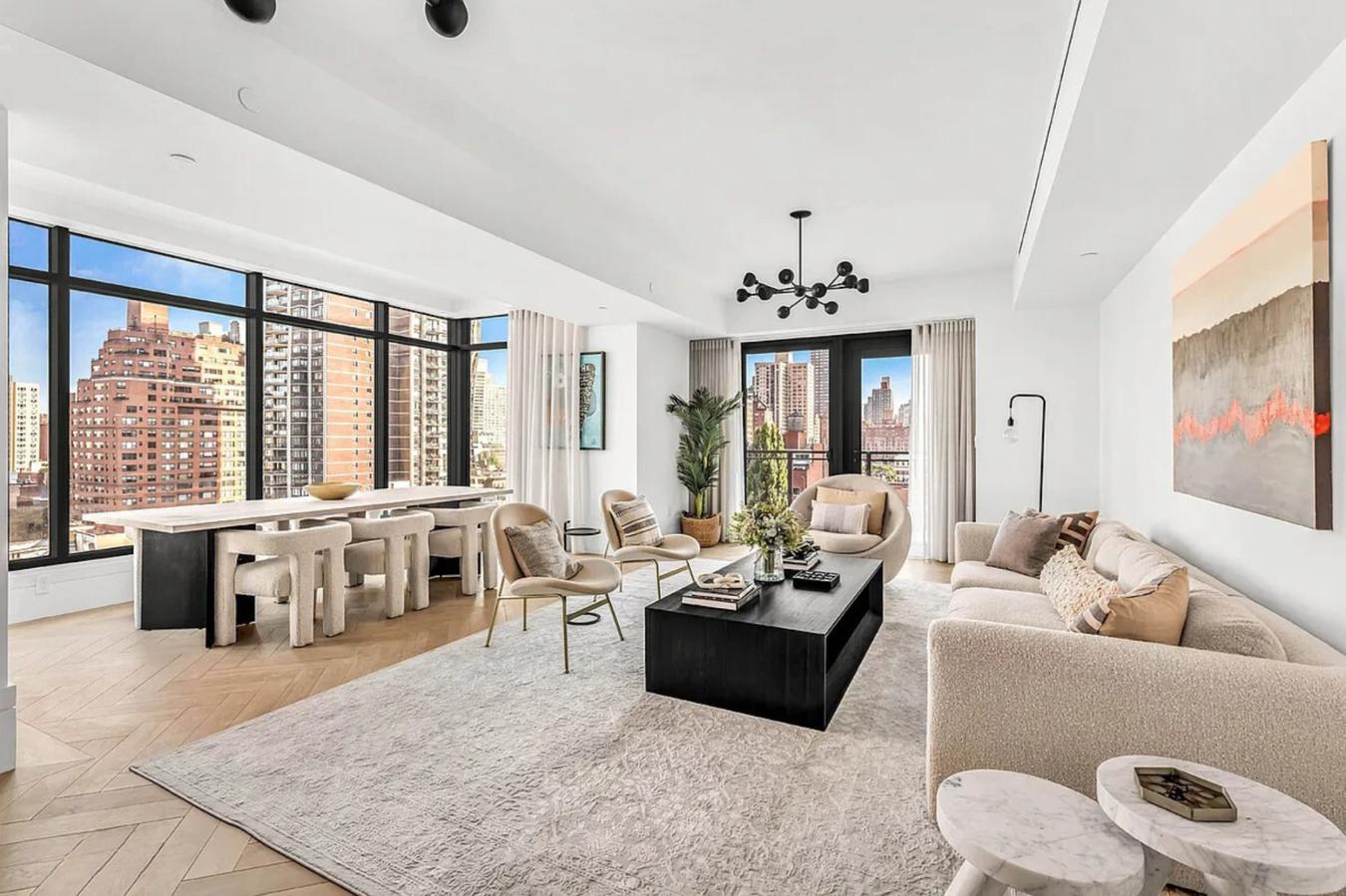 a living room with furniture and large windows