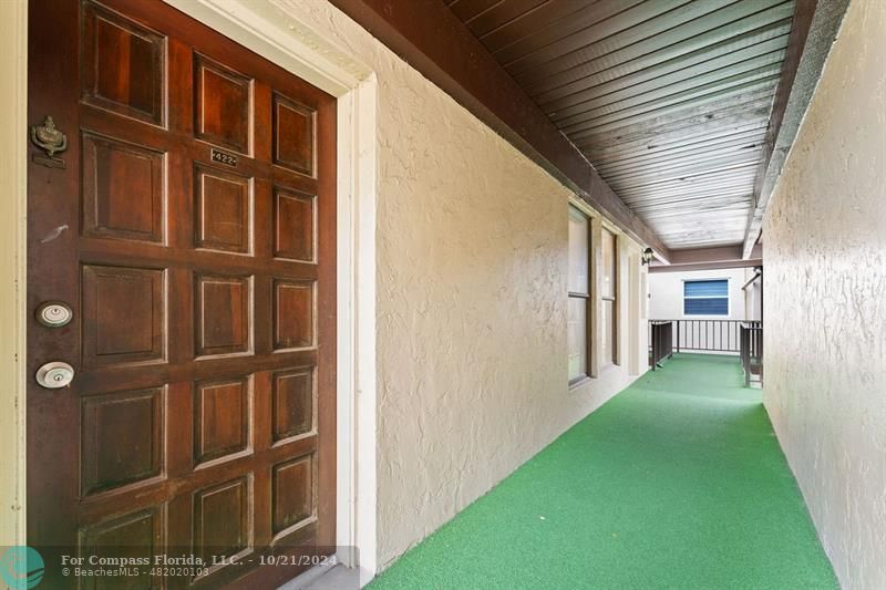 a view of a porch with wooden floor and stairs