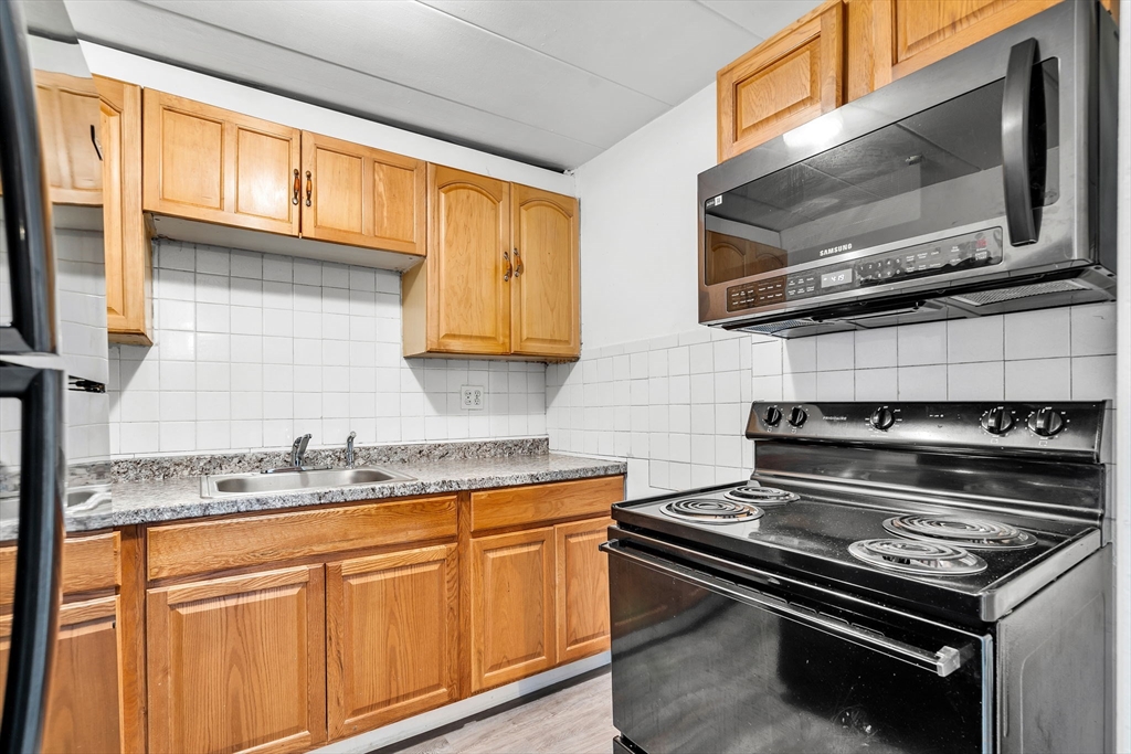 a kitchen with stainless steel appliances granite countertop a stove and a microwave