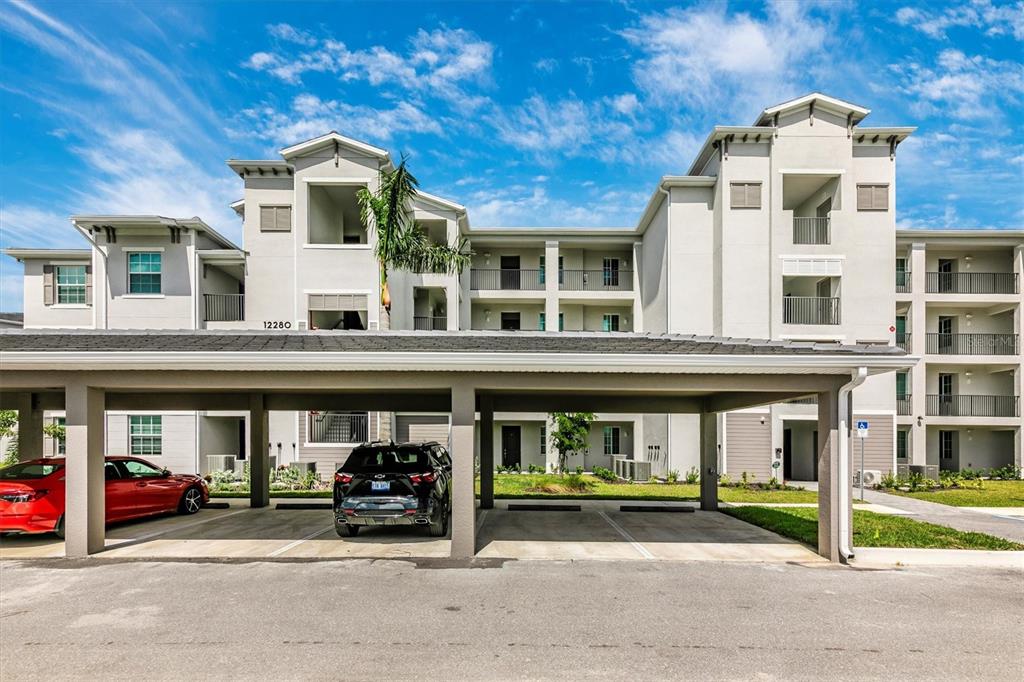 a view of a building with car park in front of it