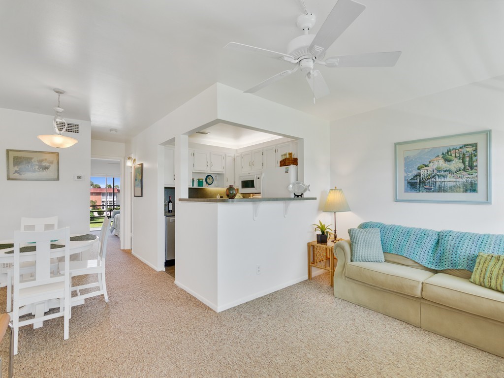 a living room with furniture and kitchen view