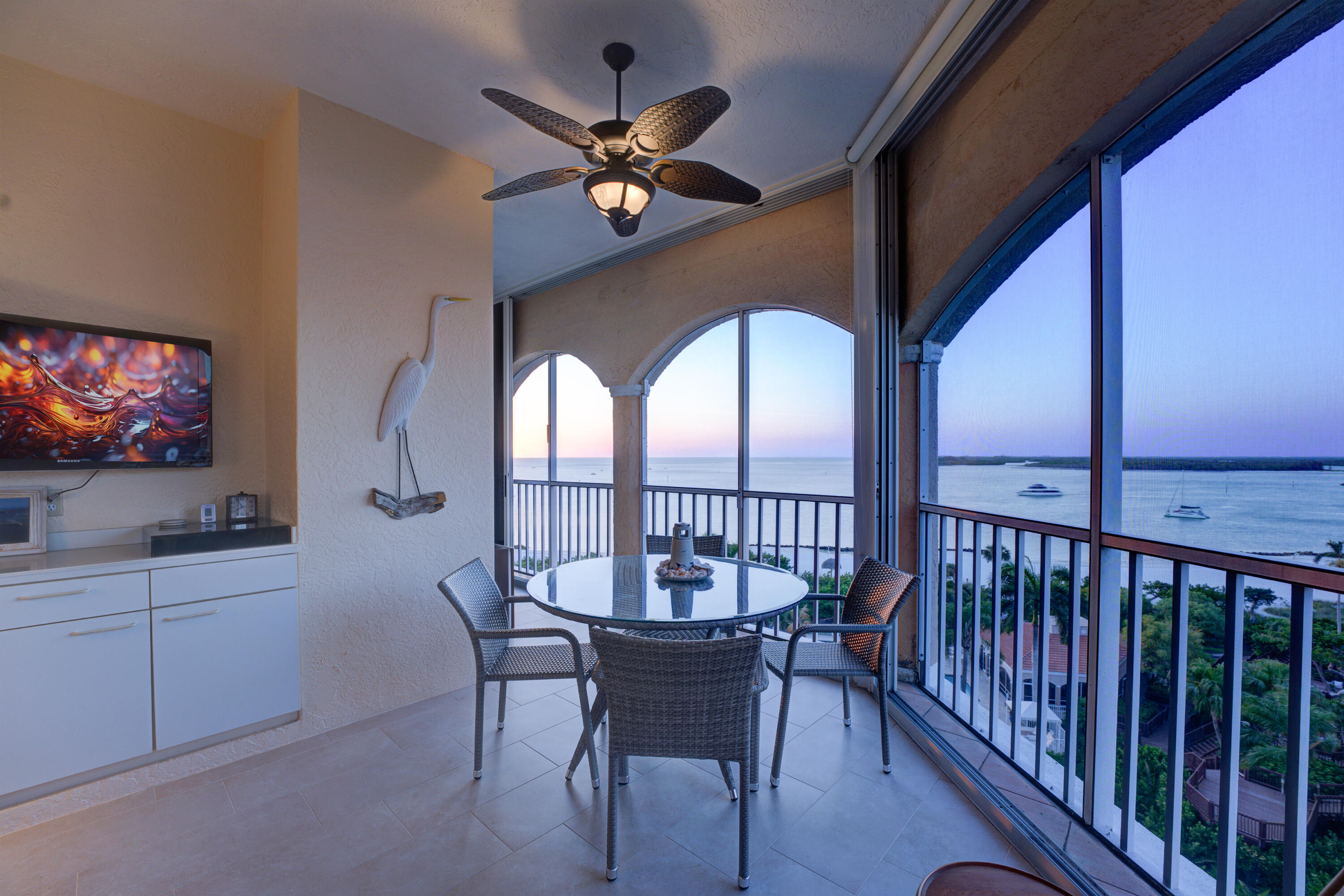 a view of a livingroom with furniture fan window and wooden floor