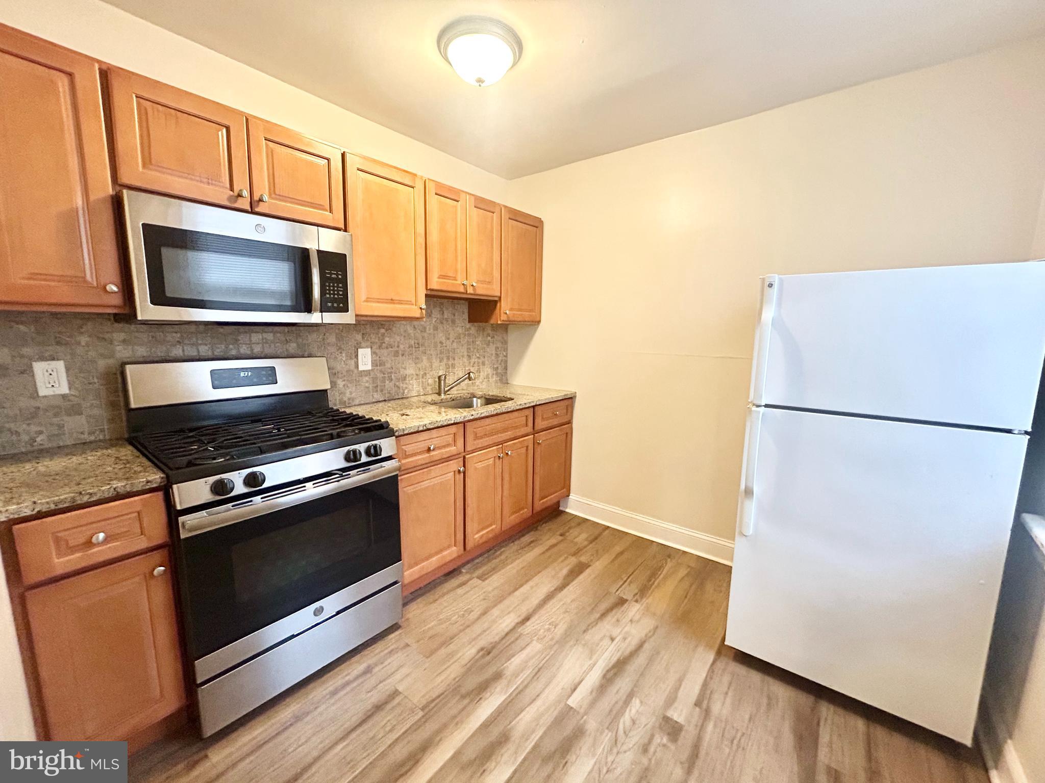 a kitchen with a refrigerator stove and microwave