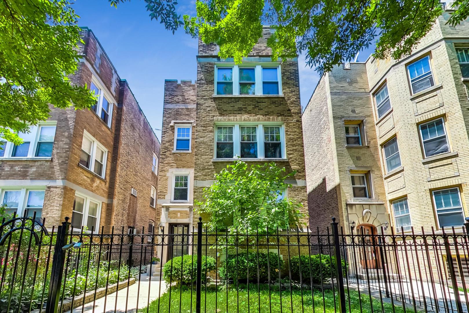 a view of a brick building next to a yard