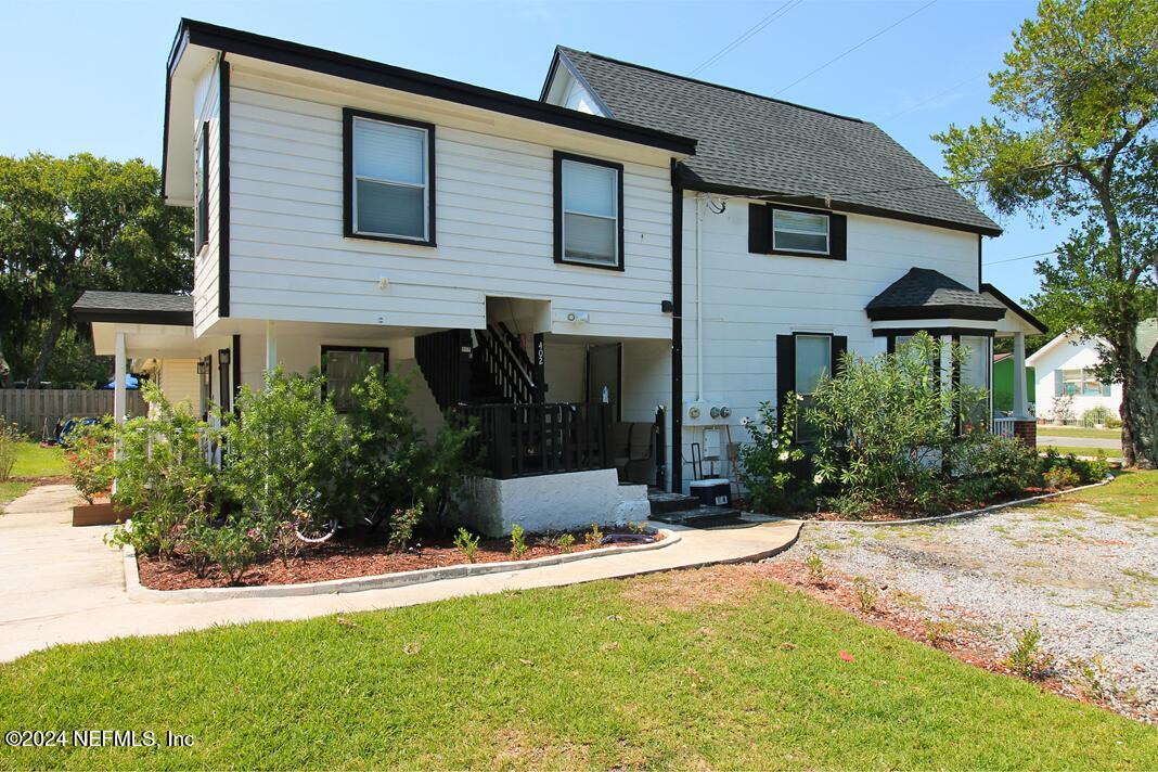 a view of a house with a yard and plants