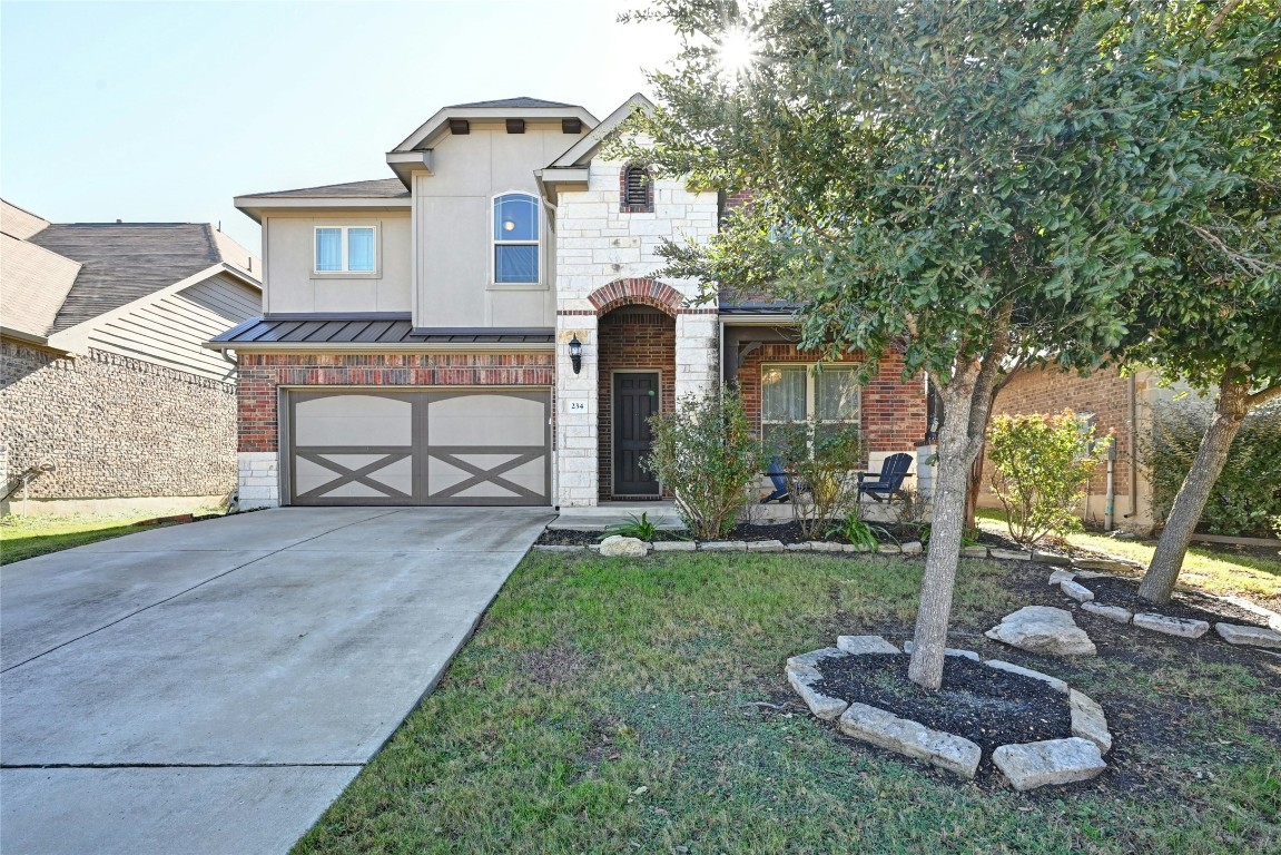 a front view of a house with garden