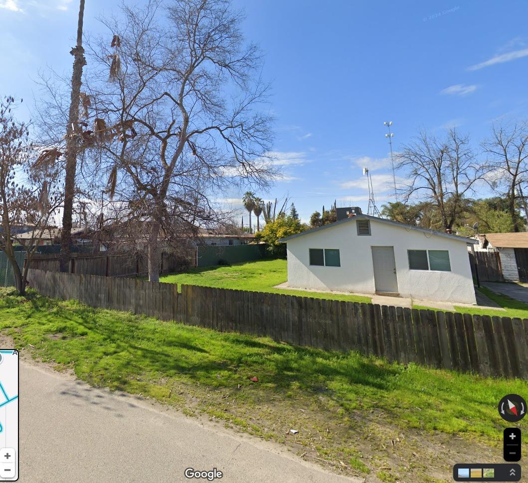 a view of a house with a yard and plants