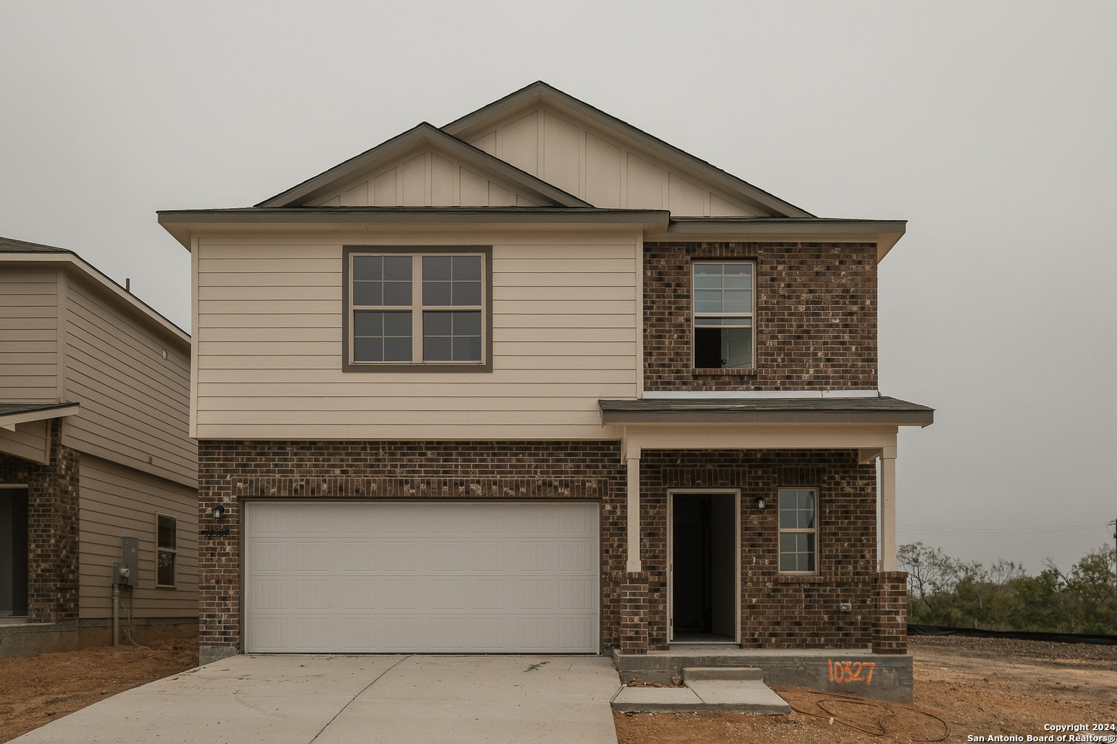 a front view of a house with a yard and garage