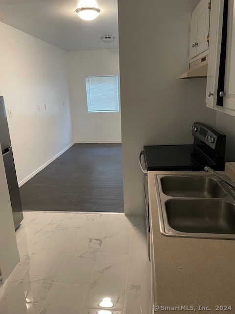 a kitchen with a sink and a refrigerator