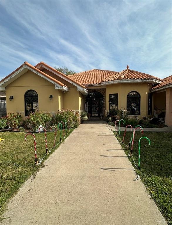 a front view of house along with a yard