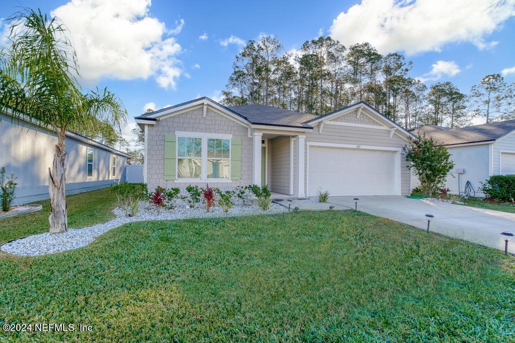 a front view of house with yard and green space