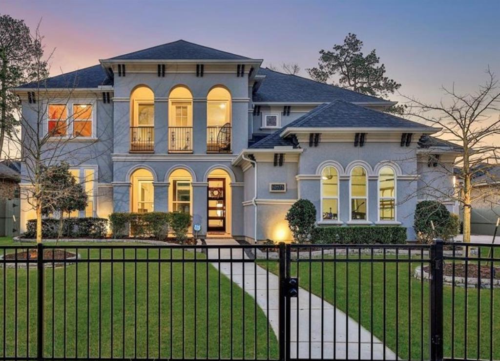 Welcome home to 10573 Lake Palmetto Drive!The grand walkway leads to the main covered entry of the home. Lush, paver trimmed flower beds frame the home, complete with uplighting