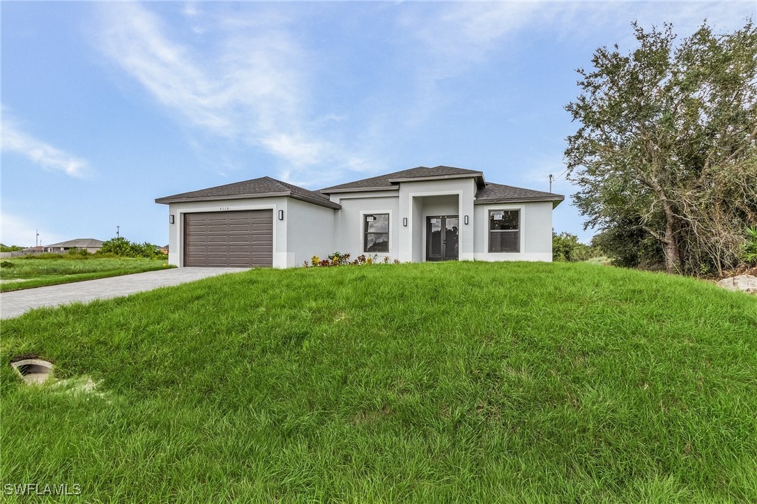 a front view of a house with garden