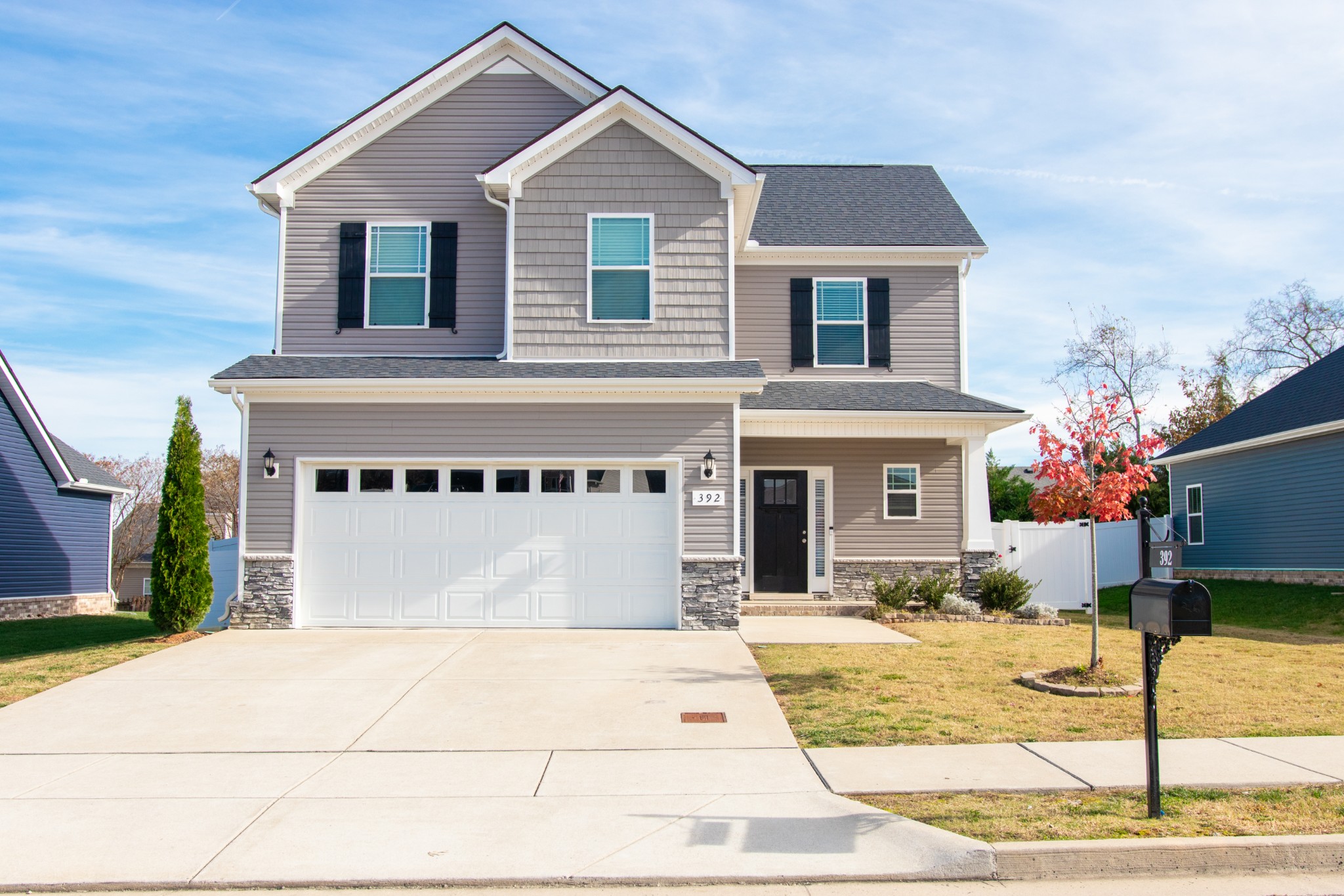 Front of home, 2 car garage for easy access, one can easily park several more cars in paved drive.