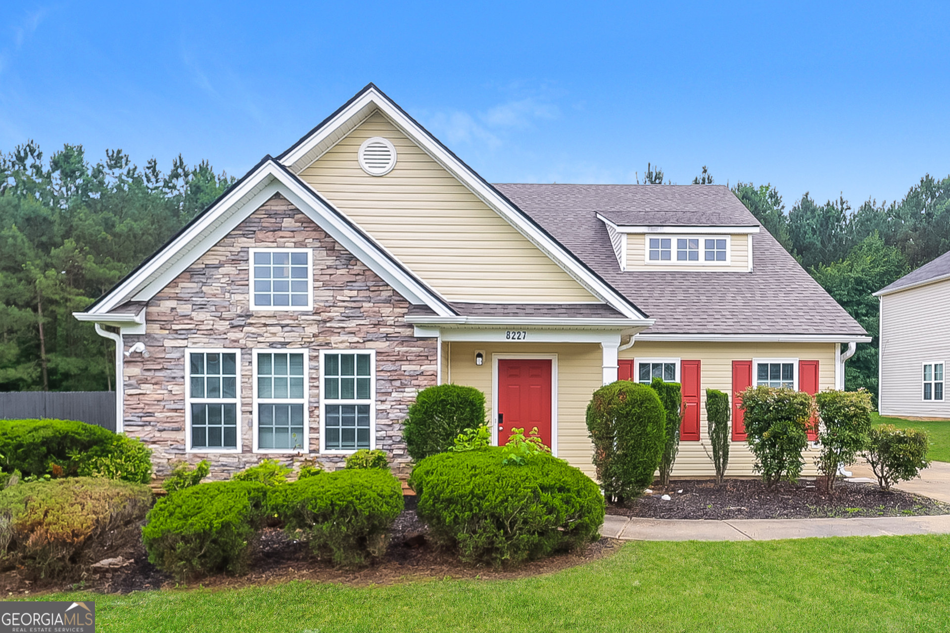 a front view of a house with garden