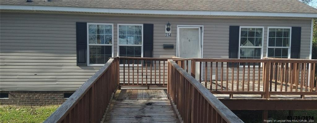 a view of a balcony with wooden floor