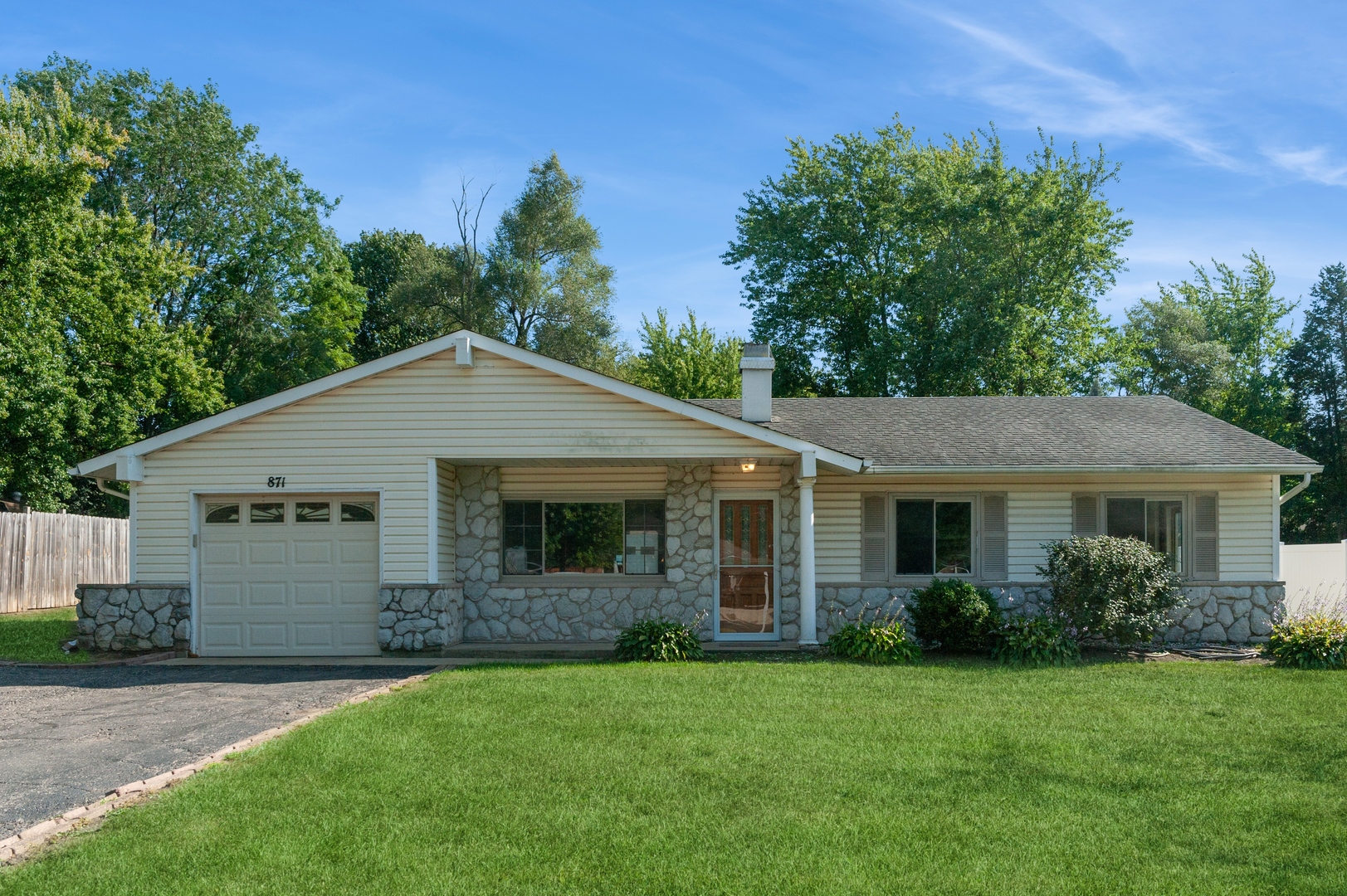 a front view of a house with a garden