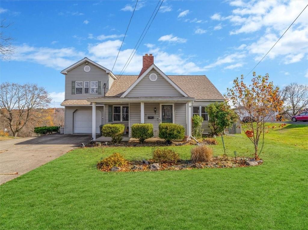 a front view of a house with a yard table and chairs