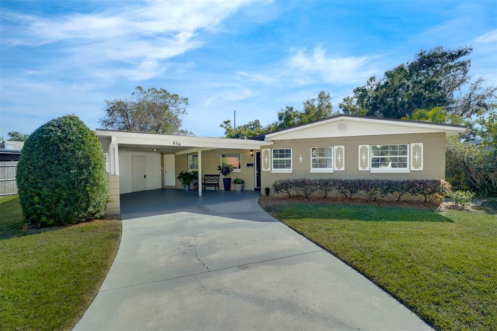 Front exterior, long driveway and additional parking pad