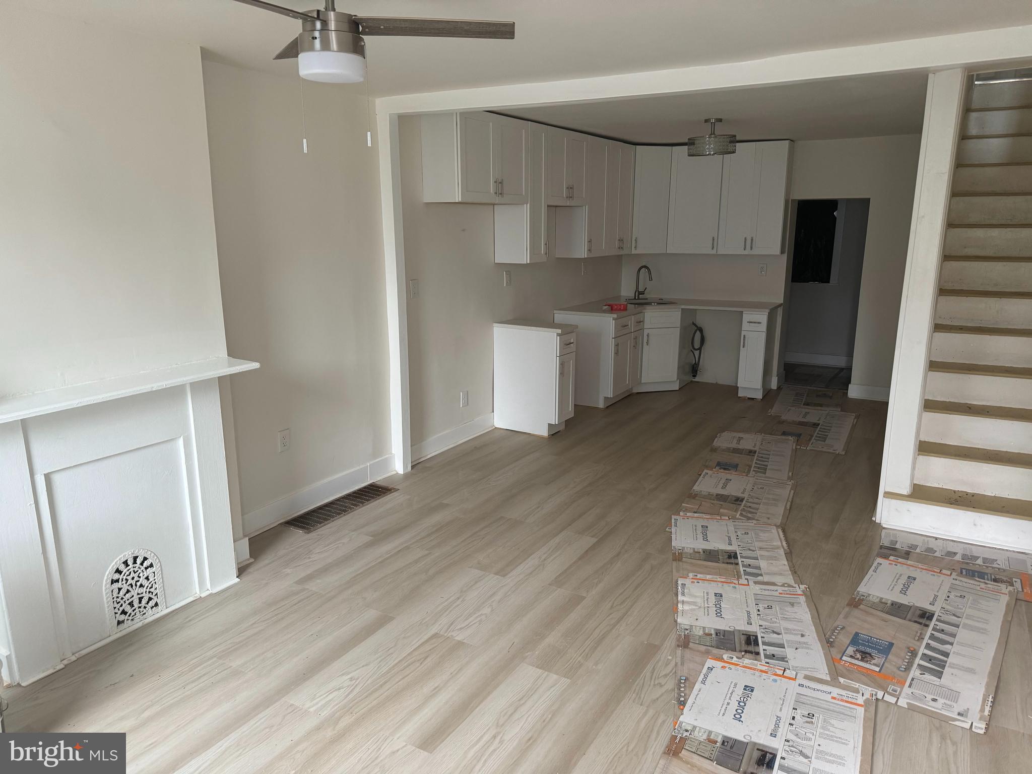 a view of kitchen with wooden floor and electronic appliances