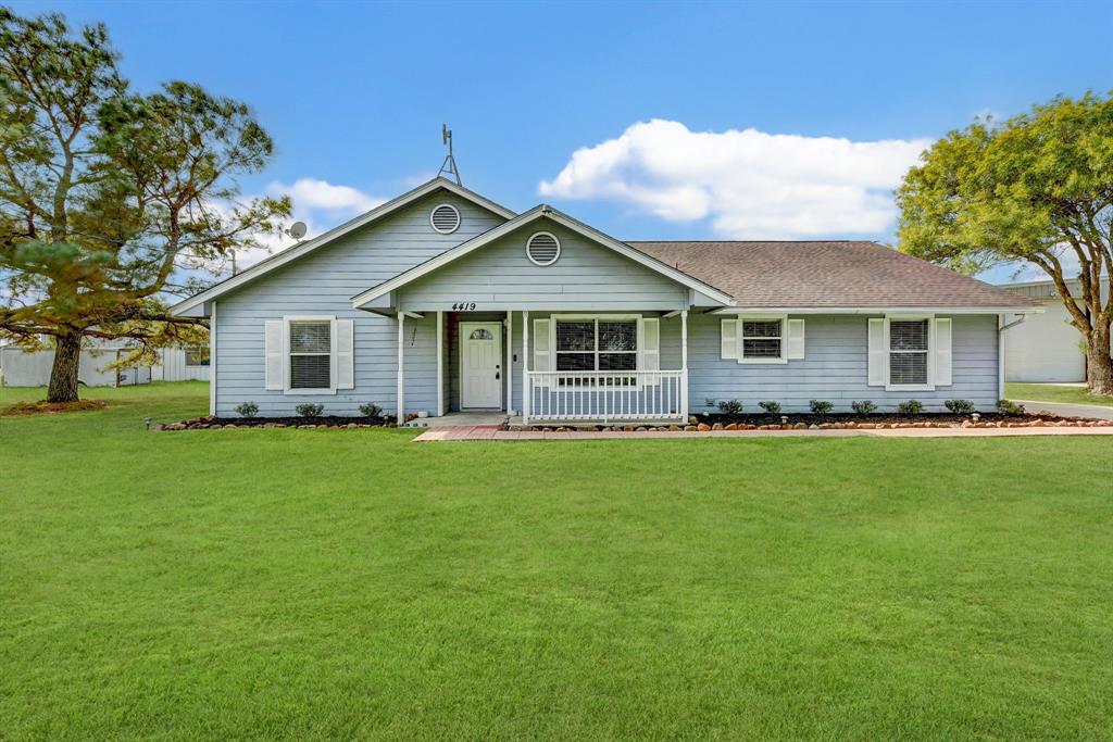 a front view of house with yard and green space