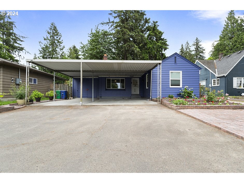 a view of a house with a backyard and a garage