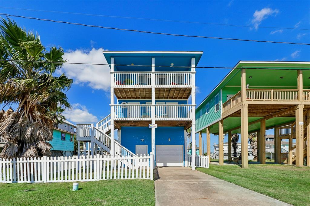 a view of a house with a yard and porch