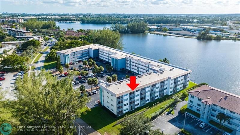 an aerial view of a house with a lake view