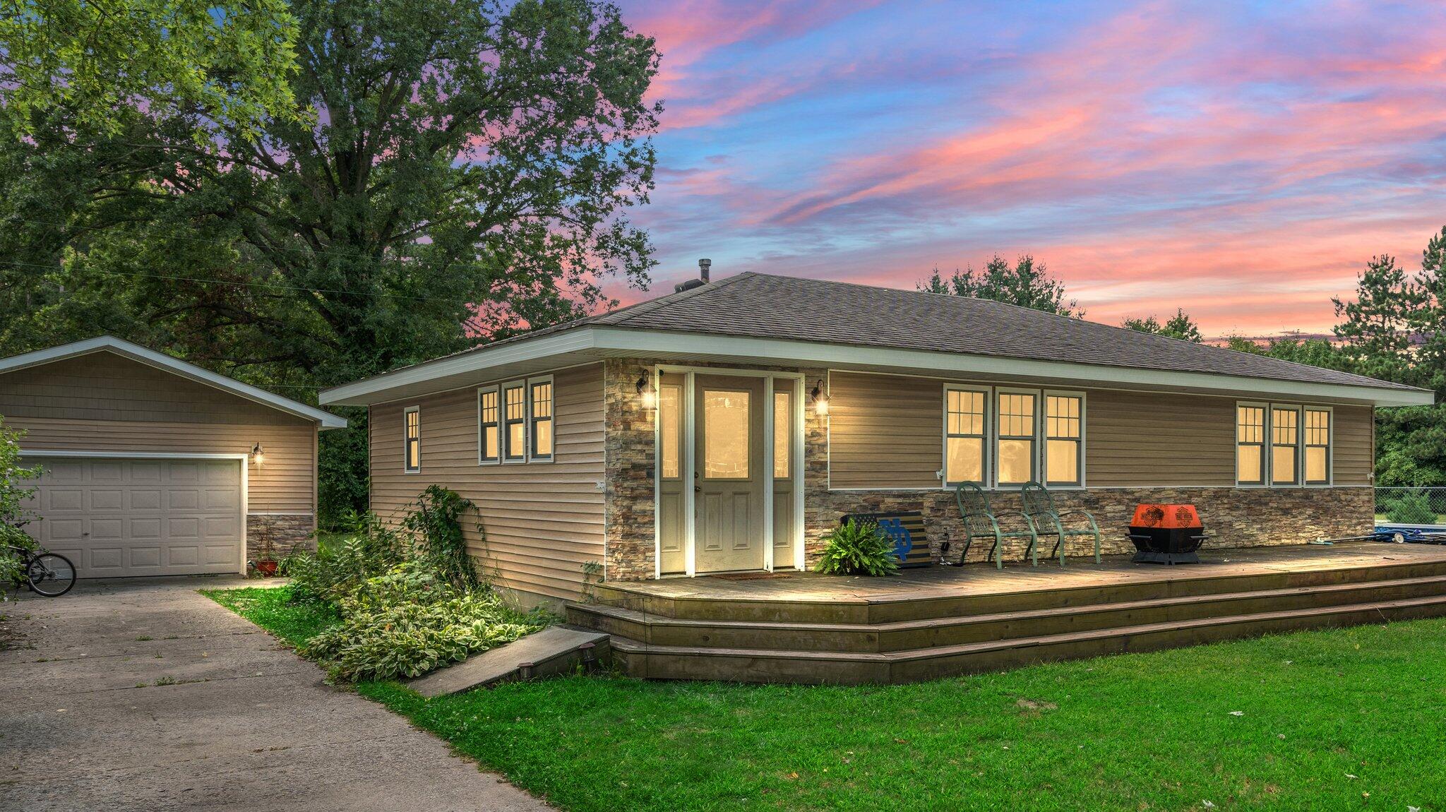 a front view of a house with a yard table and chairs