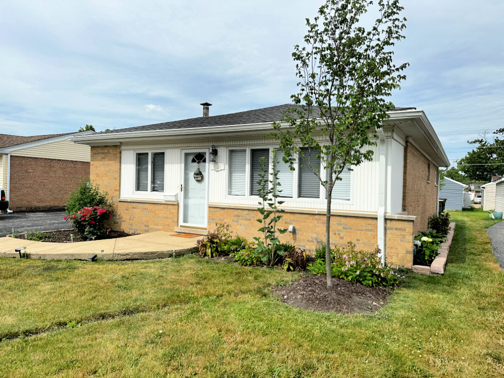 a front view of a house with garden