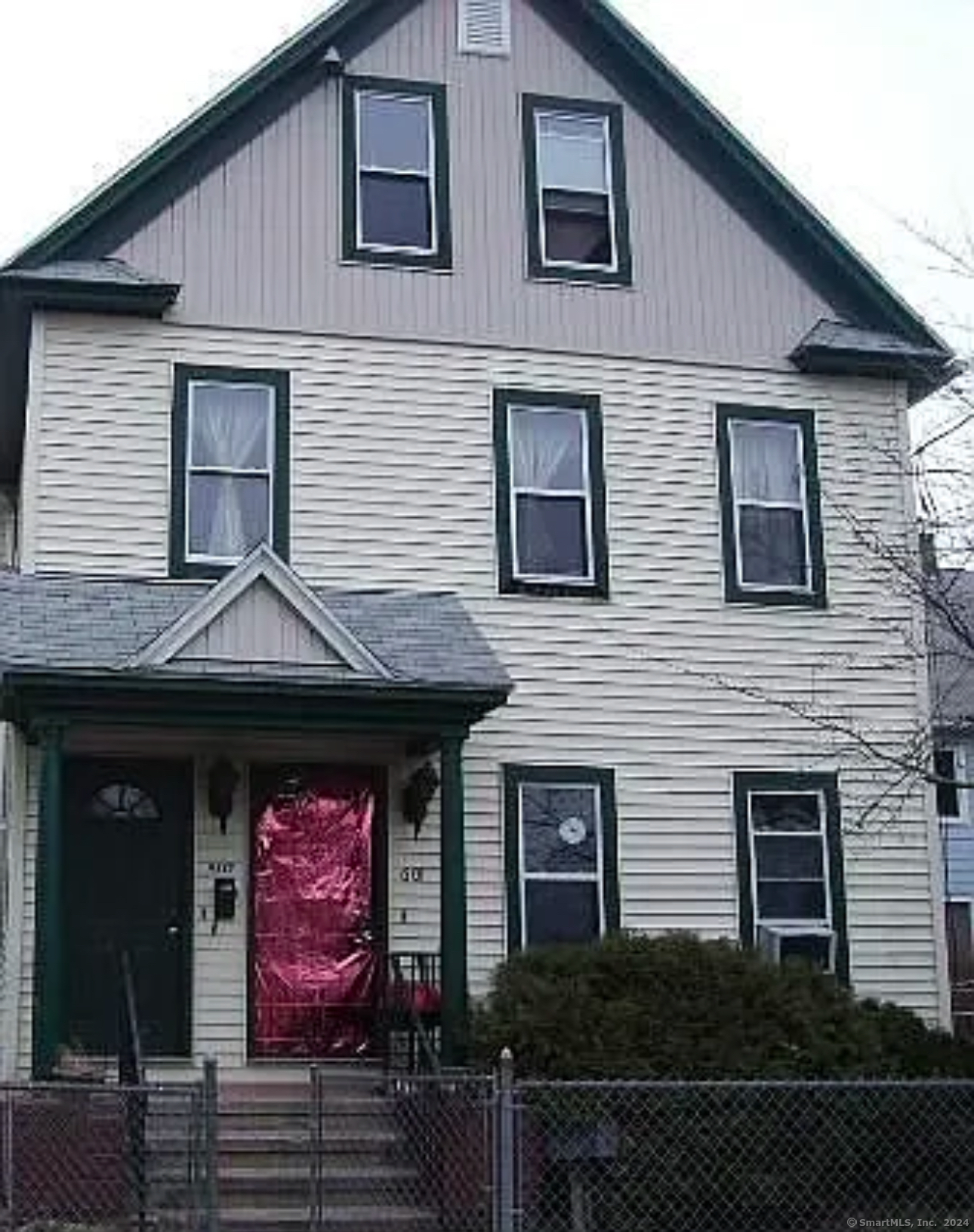 a front view of a house with plants