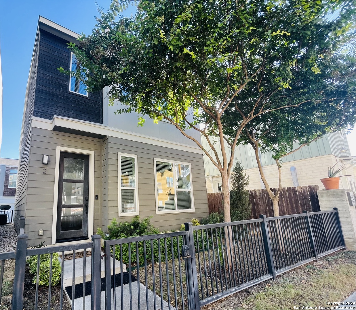 a view of a house with a small deck