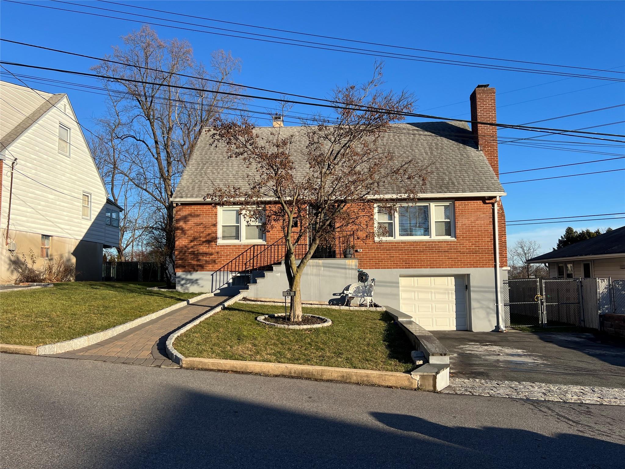 View of front of property with a front lawn and a garage