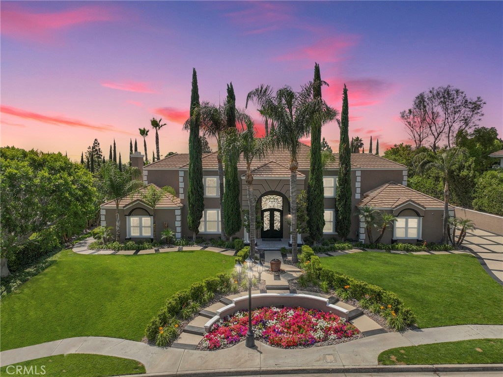 a front view of a house with garden