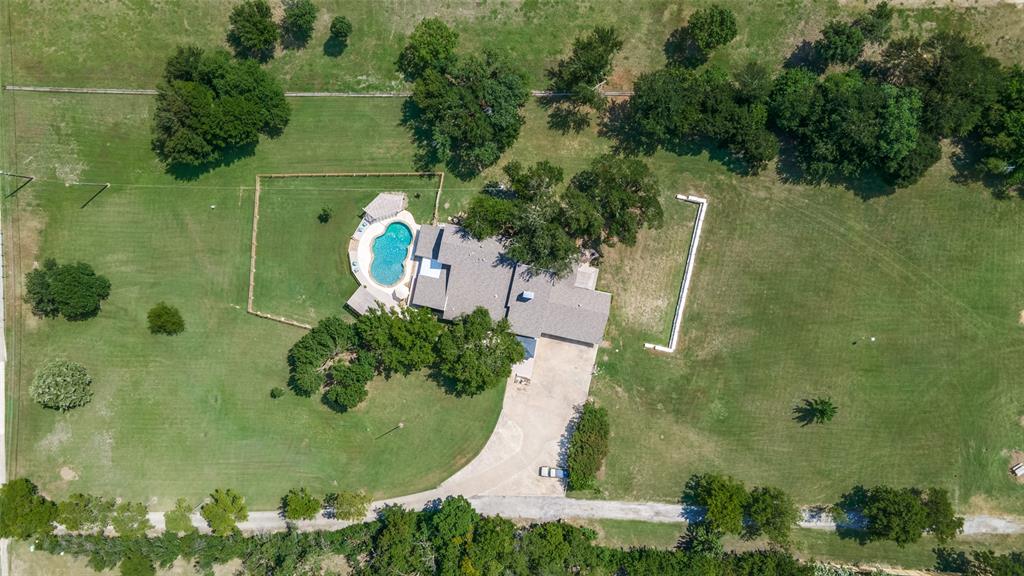 an aerial view of a residential houses with outdoor space