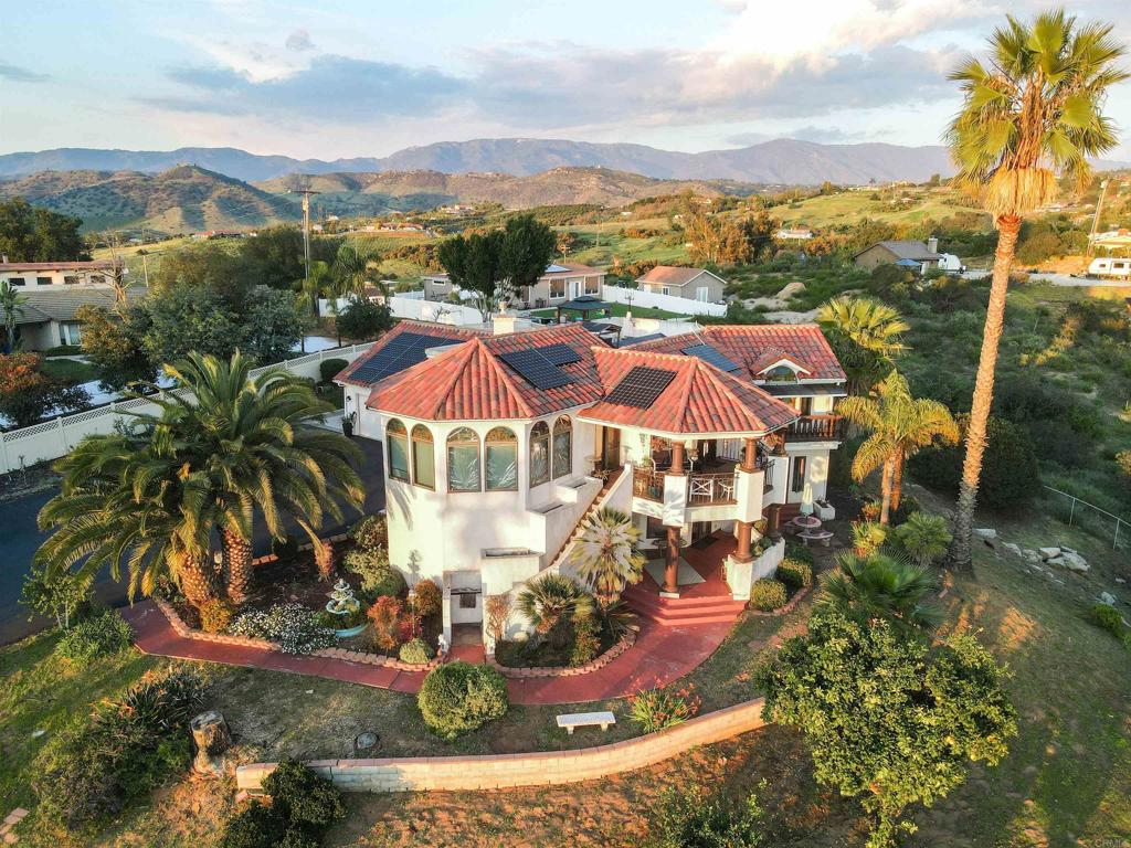 an aerial view of residential houses with outdoor space and swimming pool