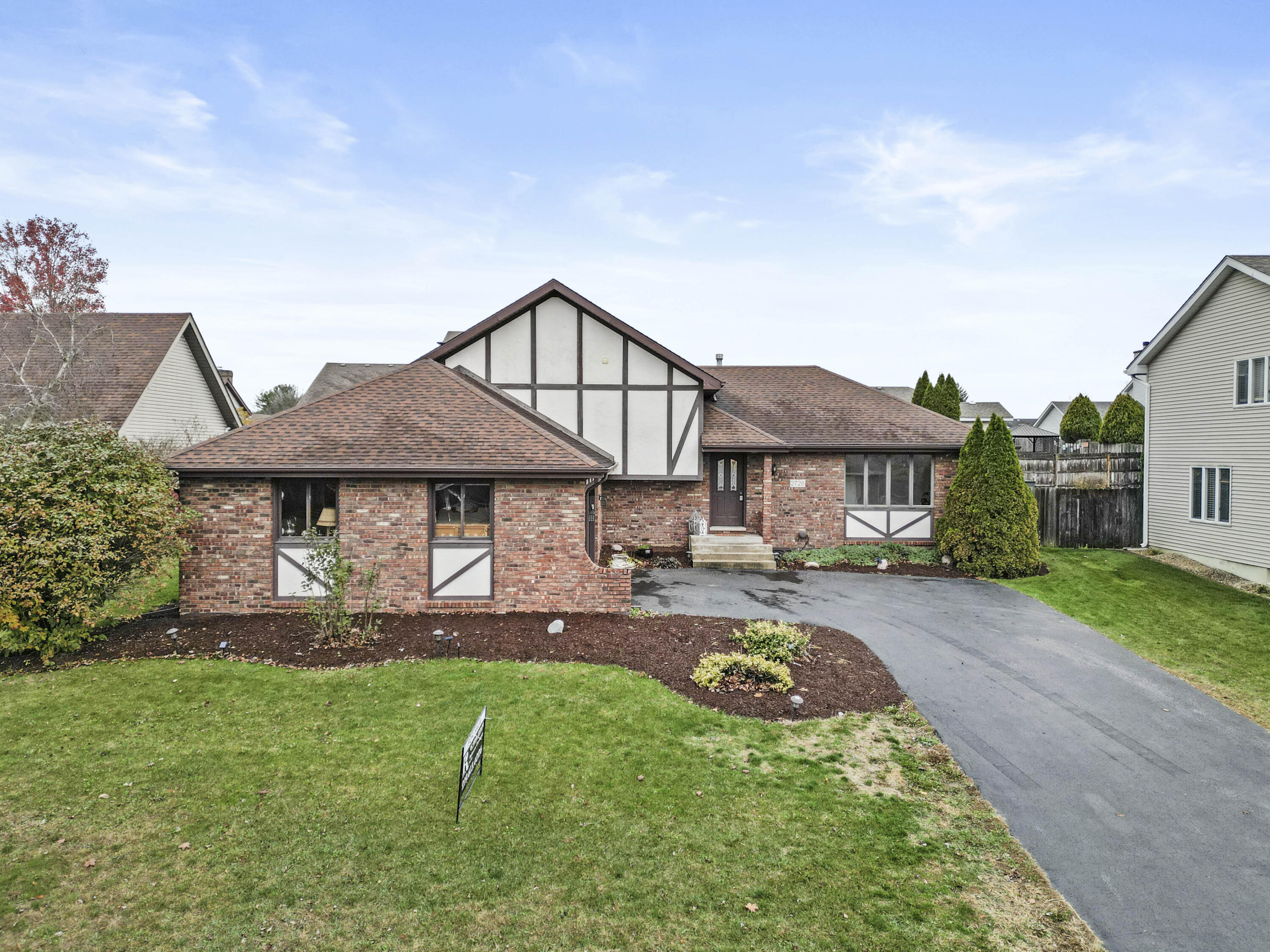 a front view of a house with garden