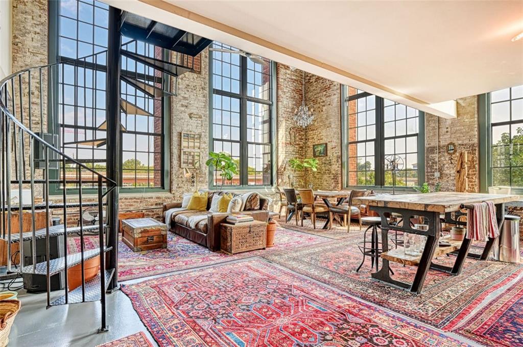 a living room with furniture and a floor to ceiling window