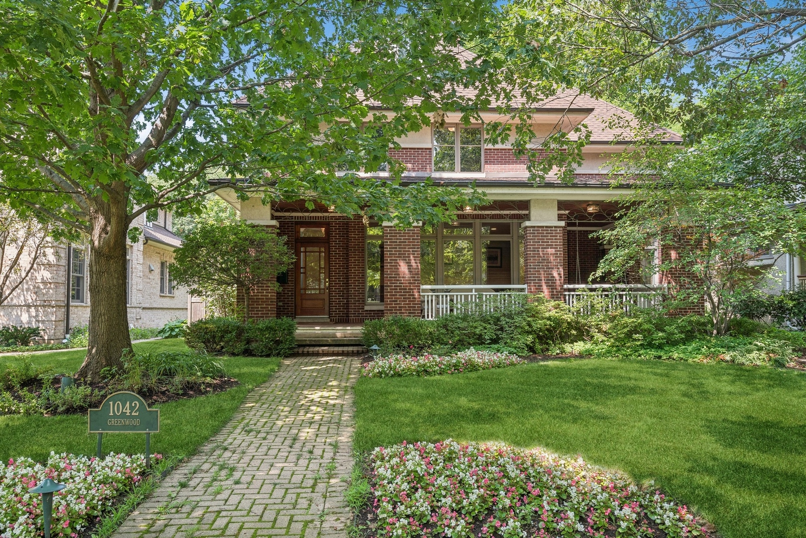 a front view of house with a garden