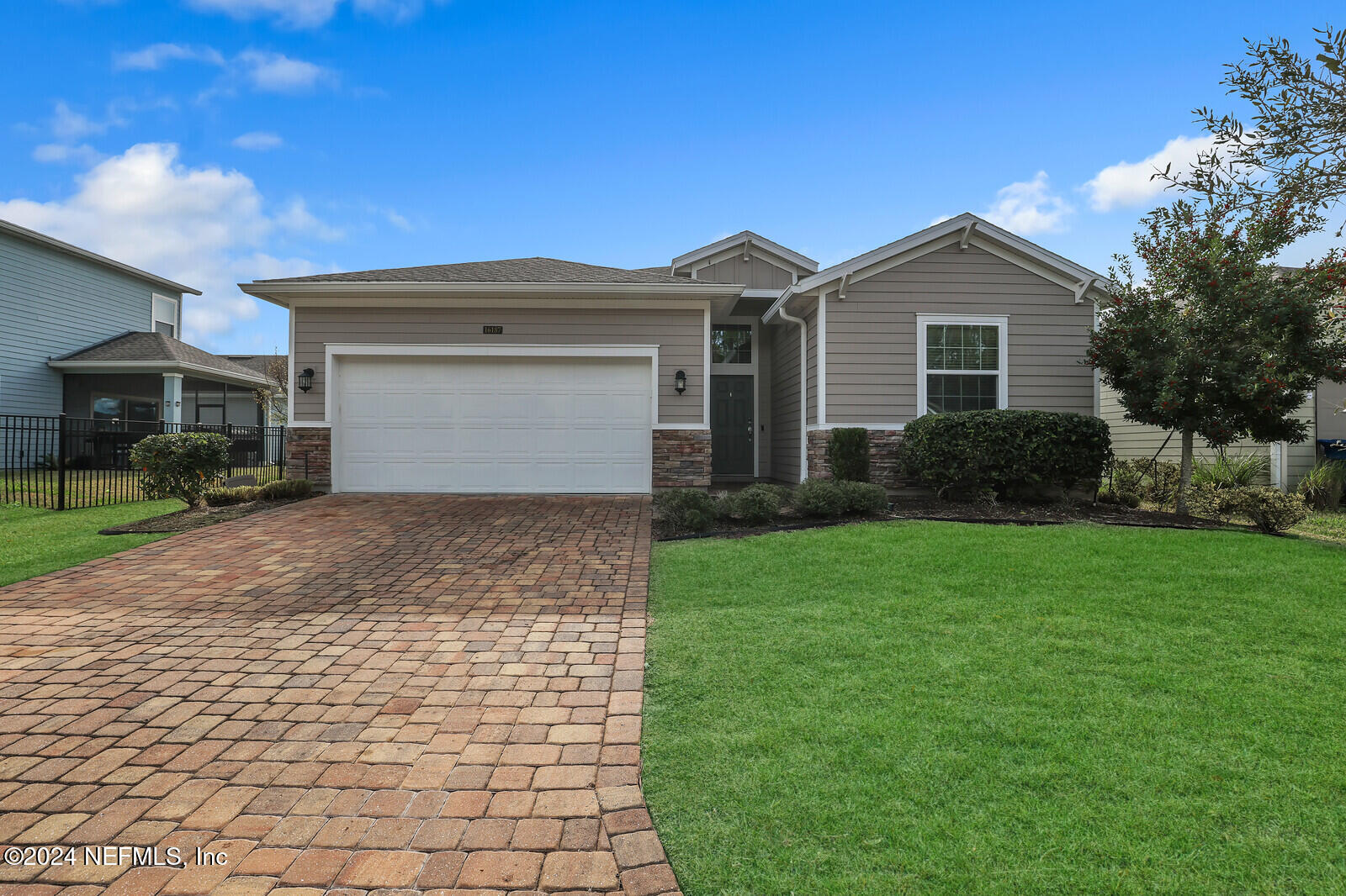 a front view of a house with a yard and garage