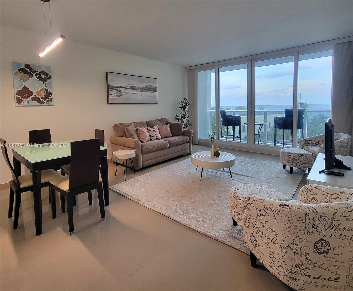 a living room with furniture and large windows