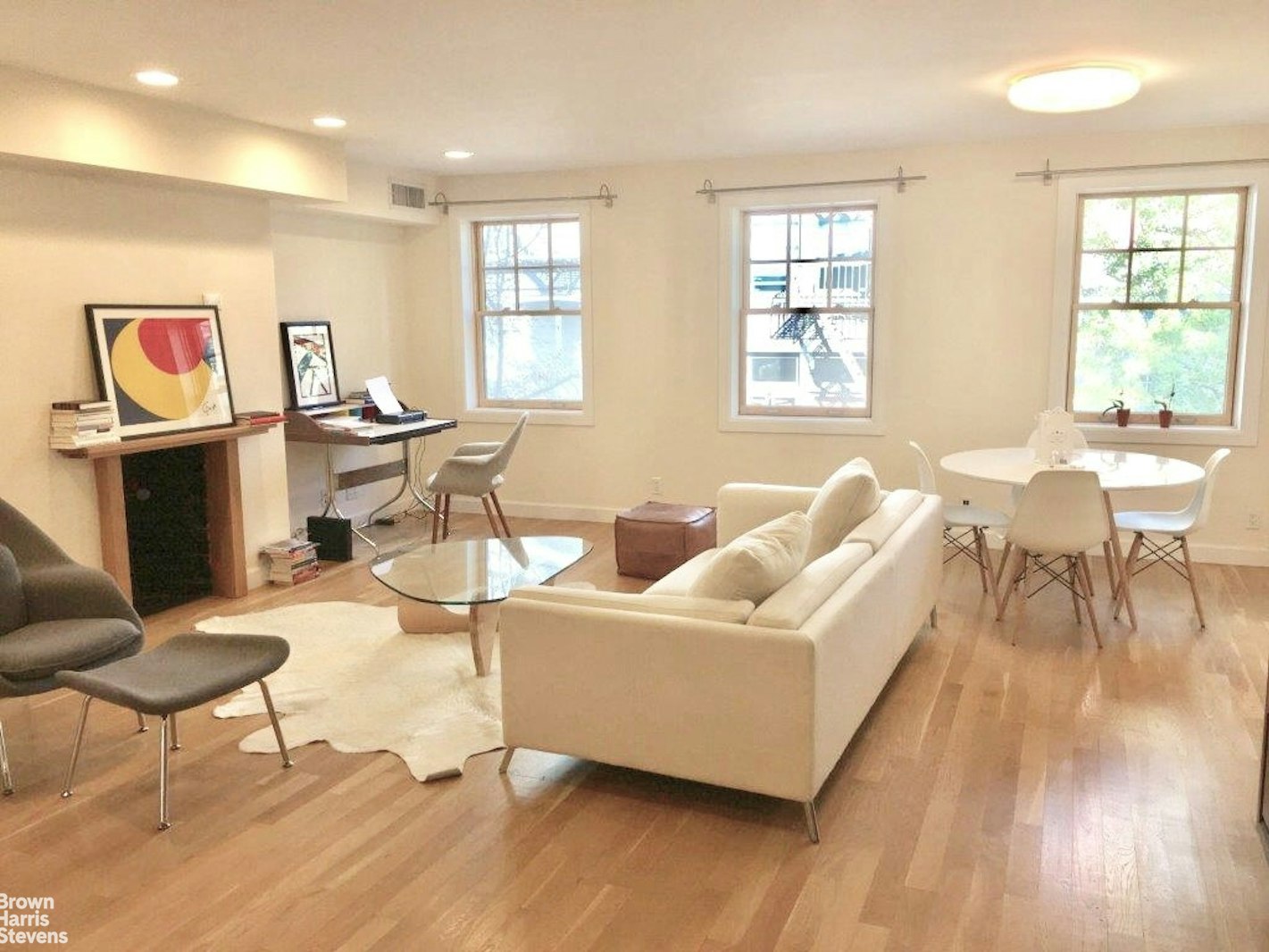 a living room with fireplace furniture and a window