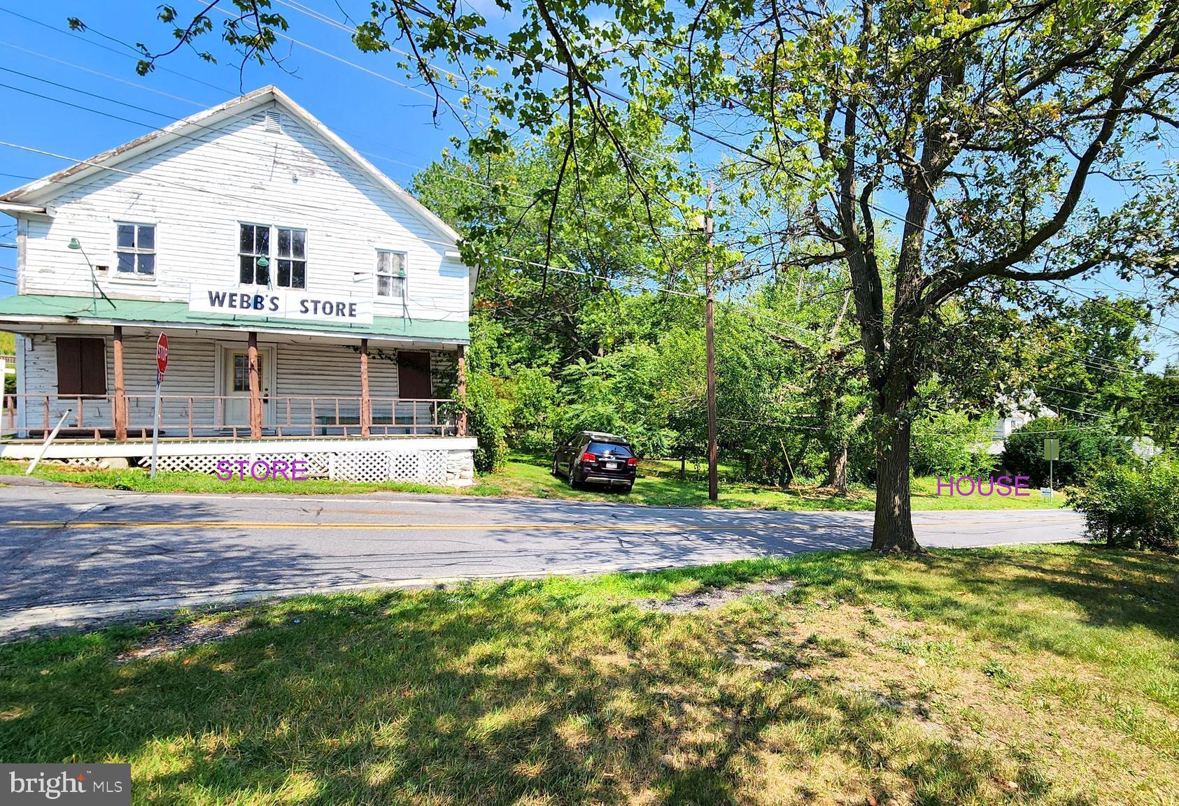 a front view of a house with a garden and yard