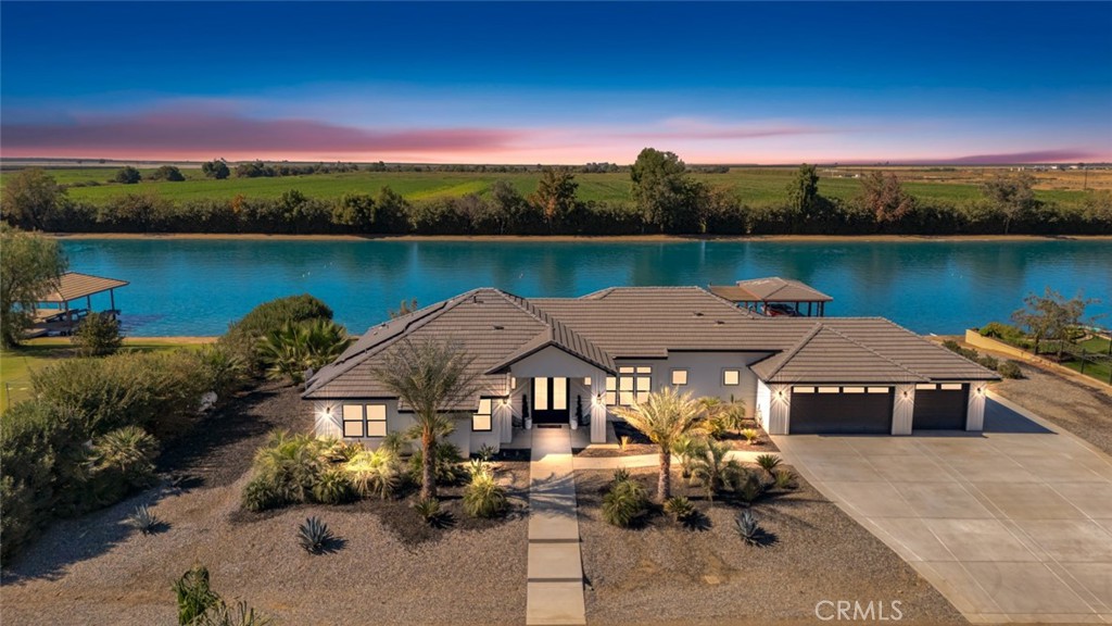 an aerial view of a house with outdoor space and lake view