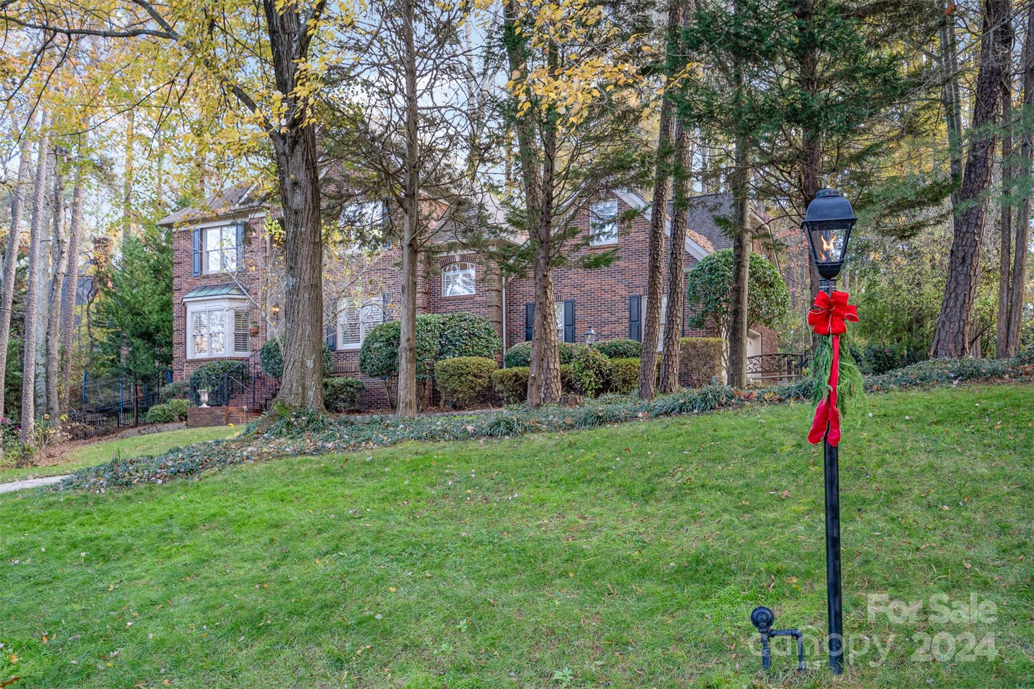 a front view of a house with a yard and fountain