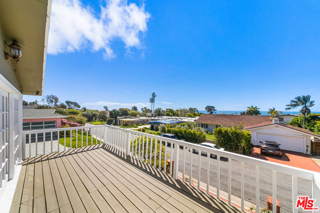 a view of balcony with wooden floor and city view