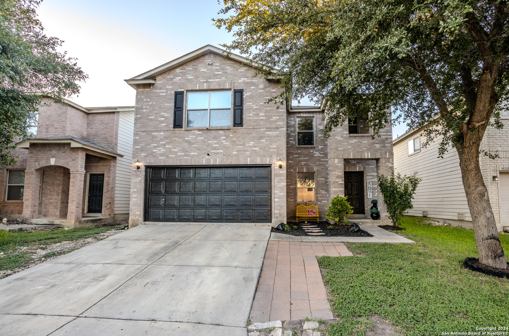 a front view of a house with a yard and garage